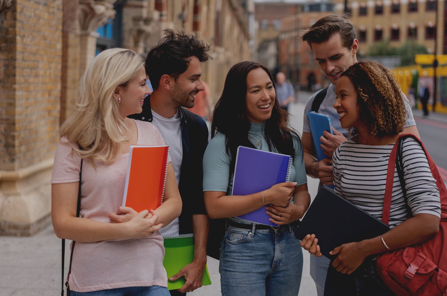 Happy group of students studying abroad in London