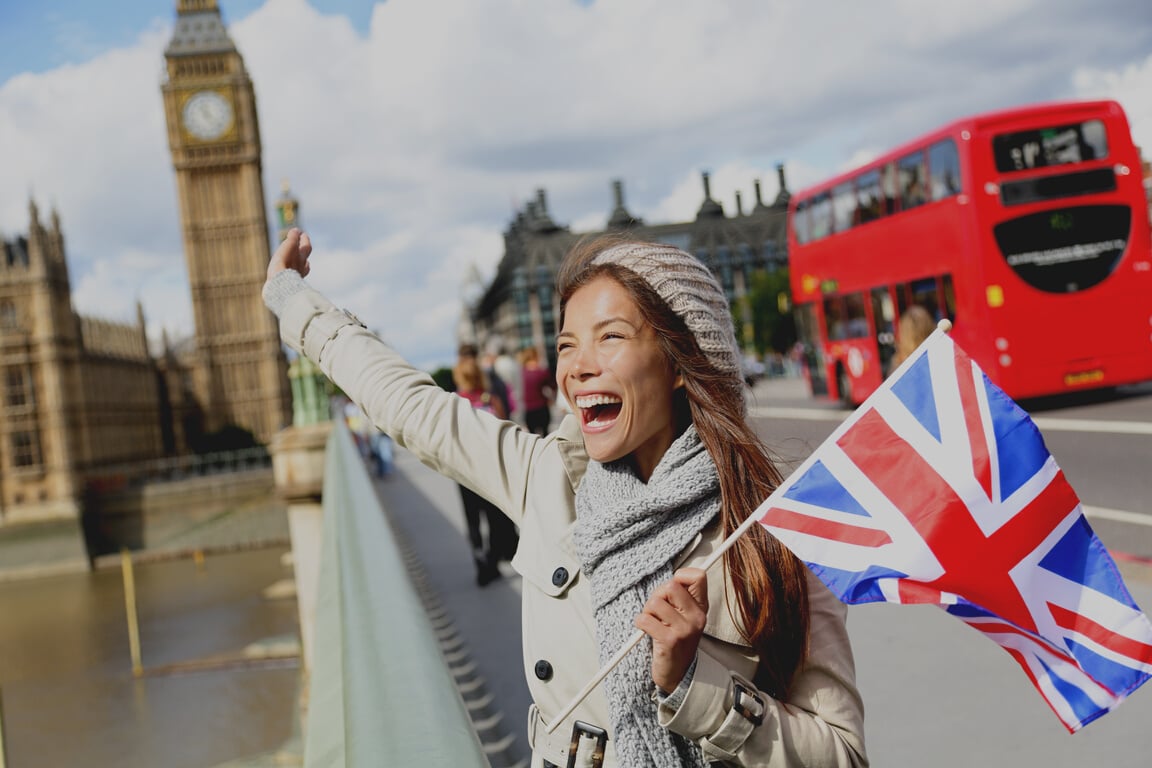 Happy Tourist Holding UK Flag by Big Ben